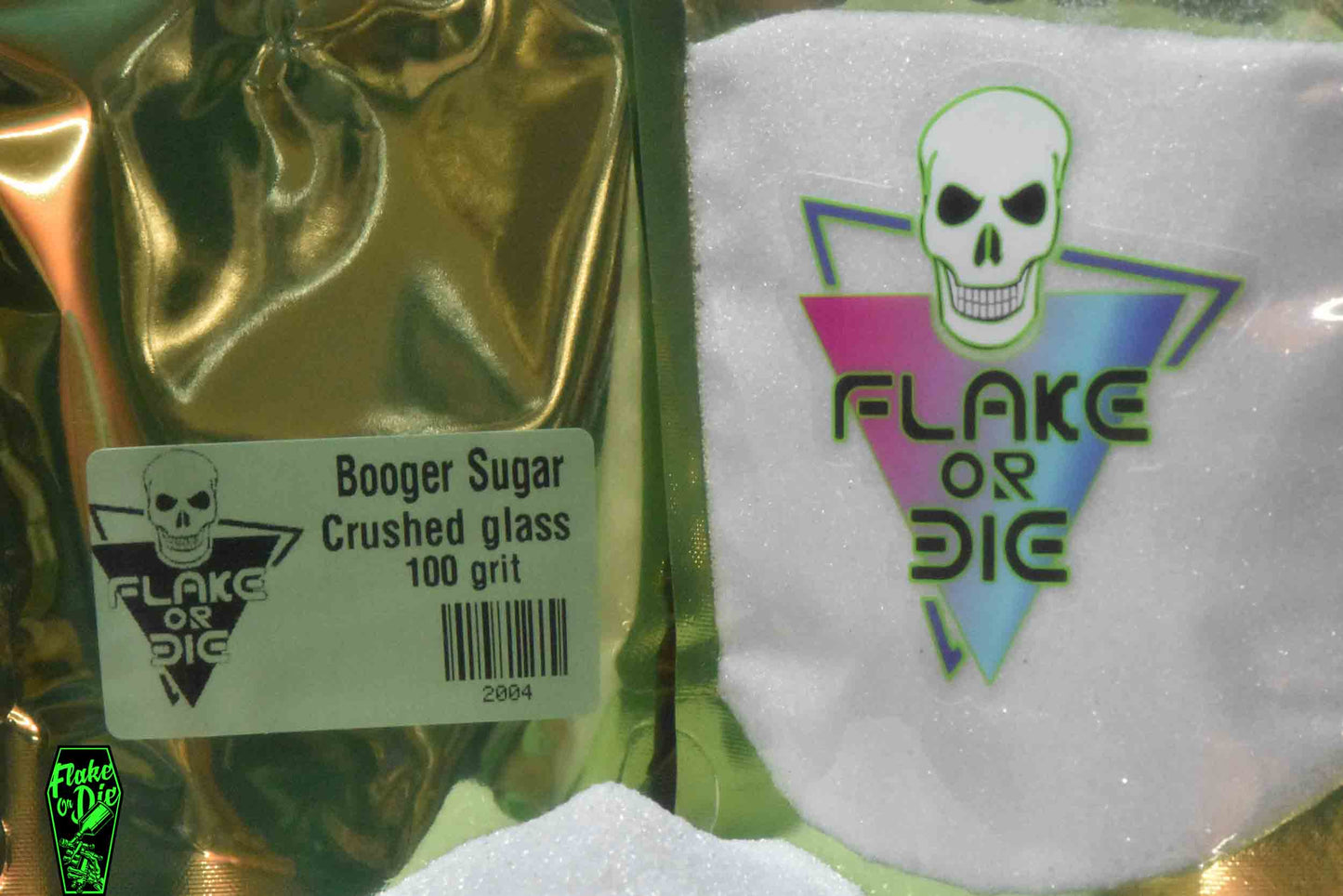 Macro photography product shot of white glass particles in a clear window foil package with company logo.