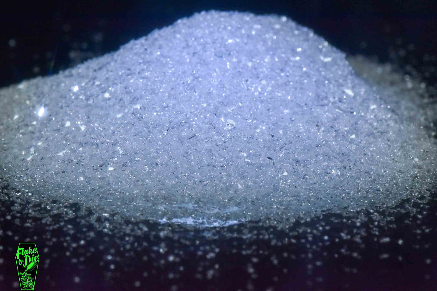 Macro photography product shot of white glass particles in a small pile.