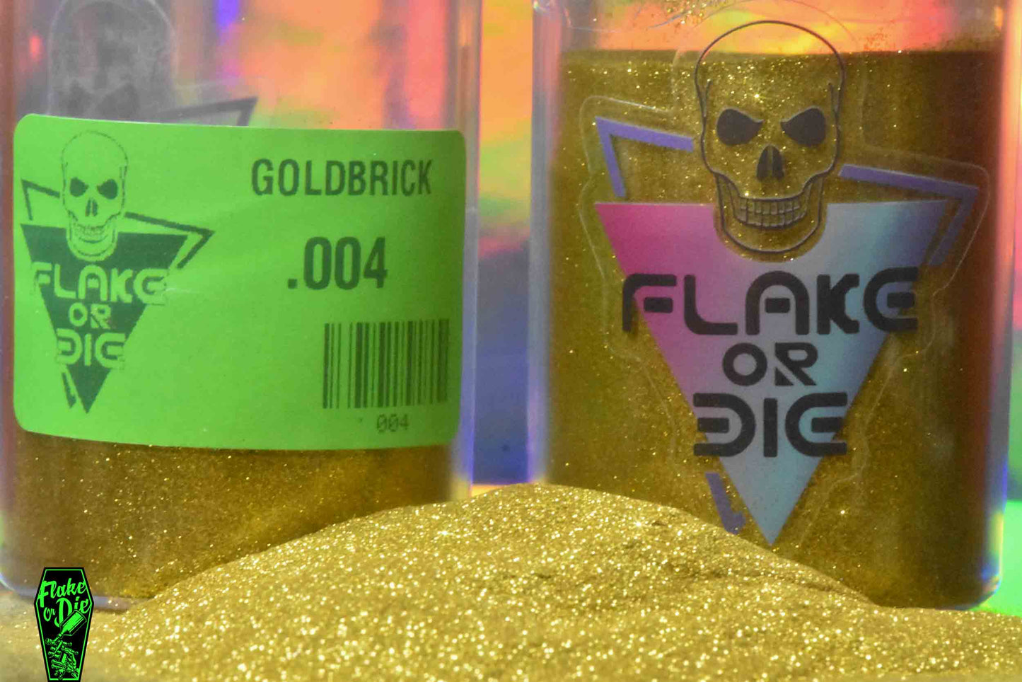 Macro photography product shot of gold metal flake in a clear jar with company logo and product labeling.