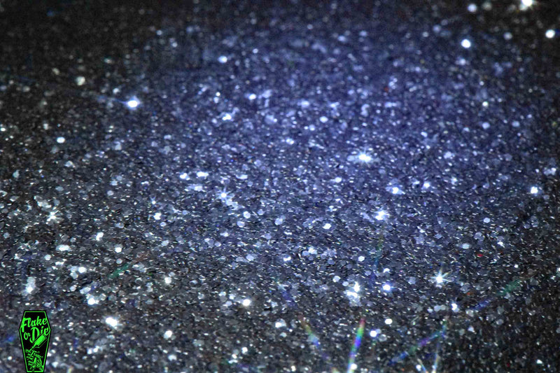Macro photography product shot of black hex shaped metal flake particles.
