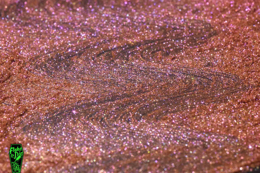 Product shot of orange purple chameleon pearl pigment power in a spread pile. Notice sparkle and color variation with light position.