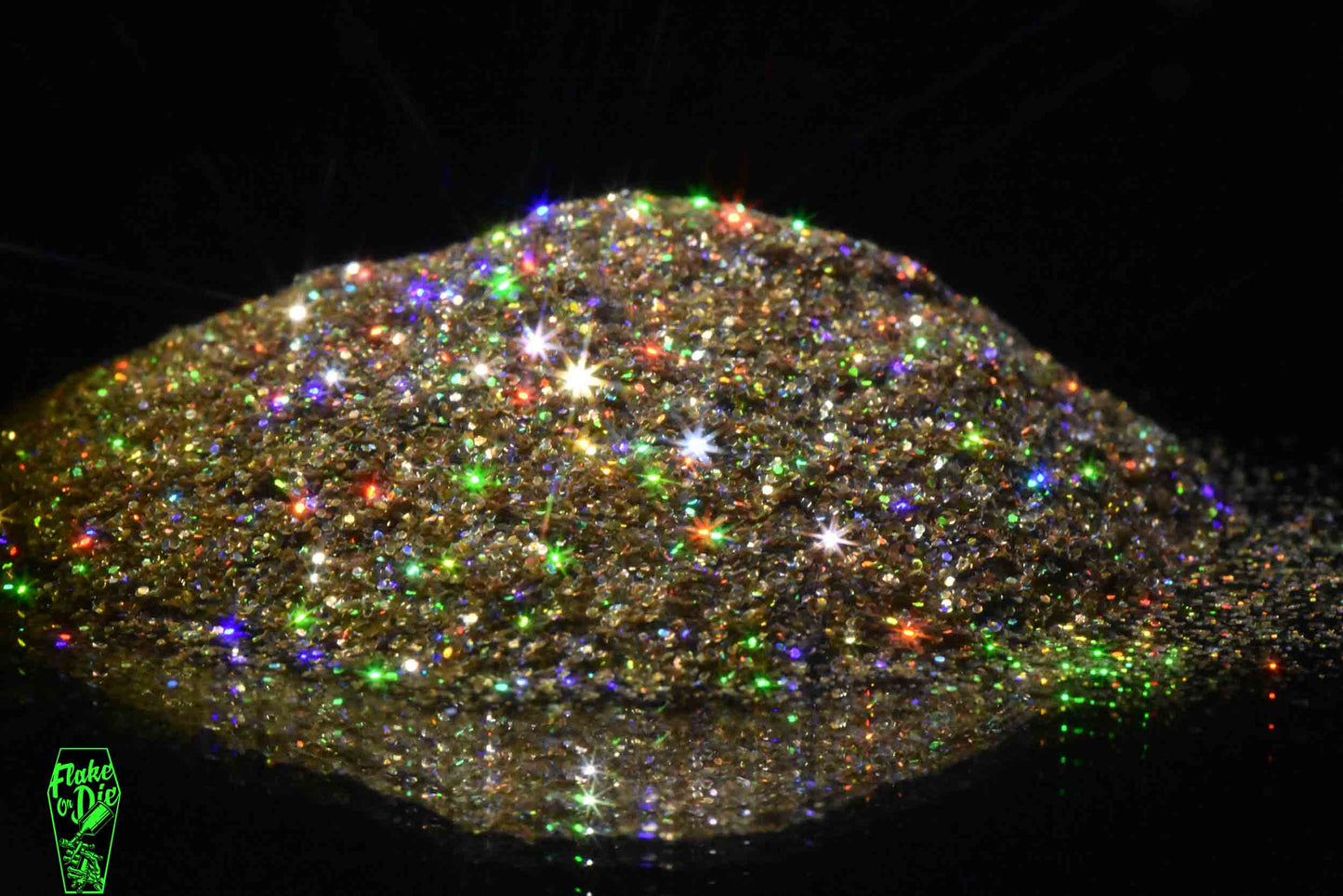 Macro photography of a smallpile of blended gold holographic metal flake particles. Distinct glitter flares of gold, purple, green and orange on the metal flake.