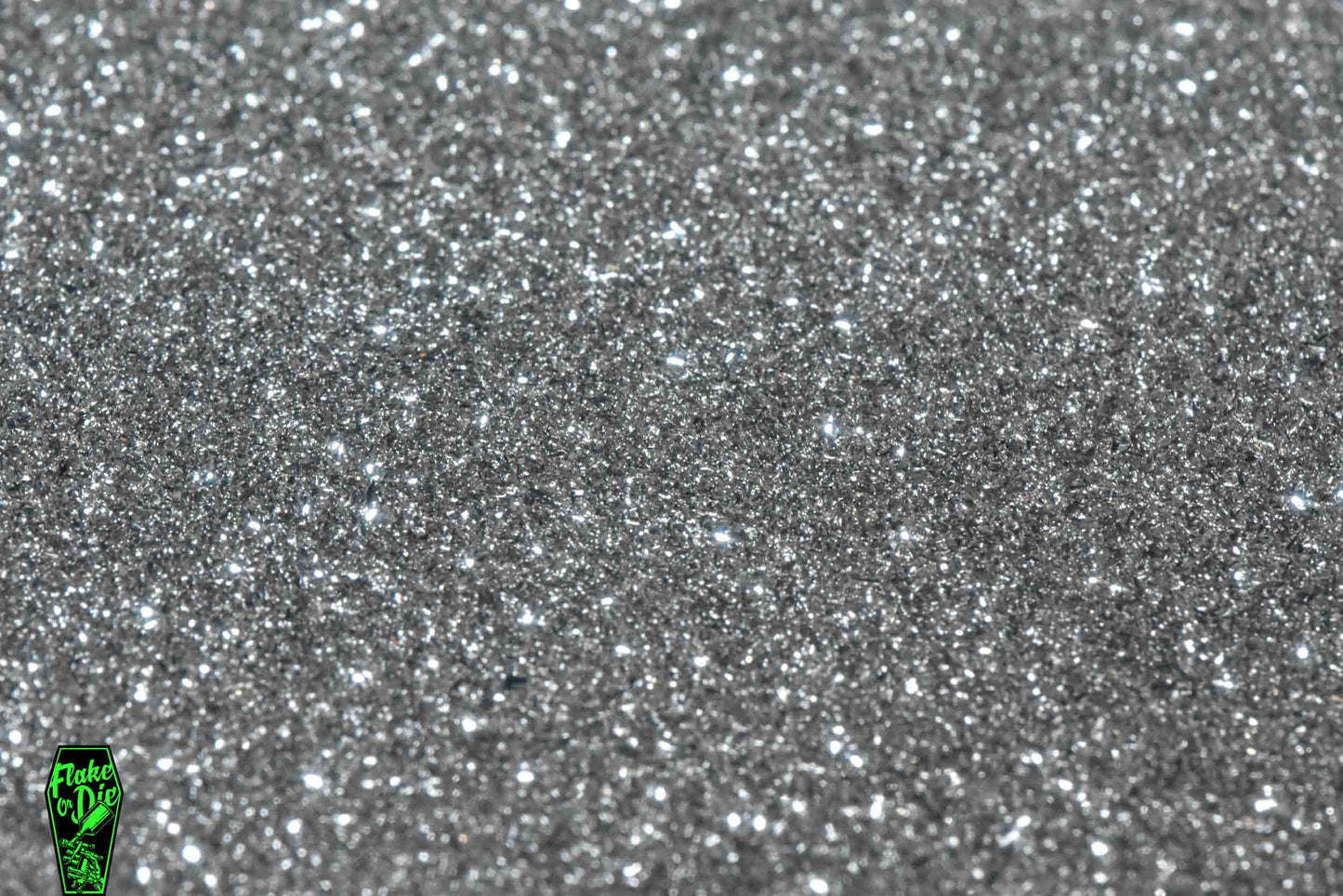 Macro photography product shot of silver glass particles in a small pile.
