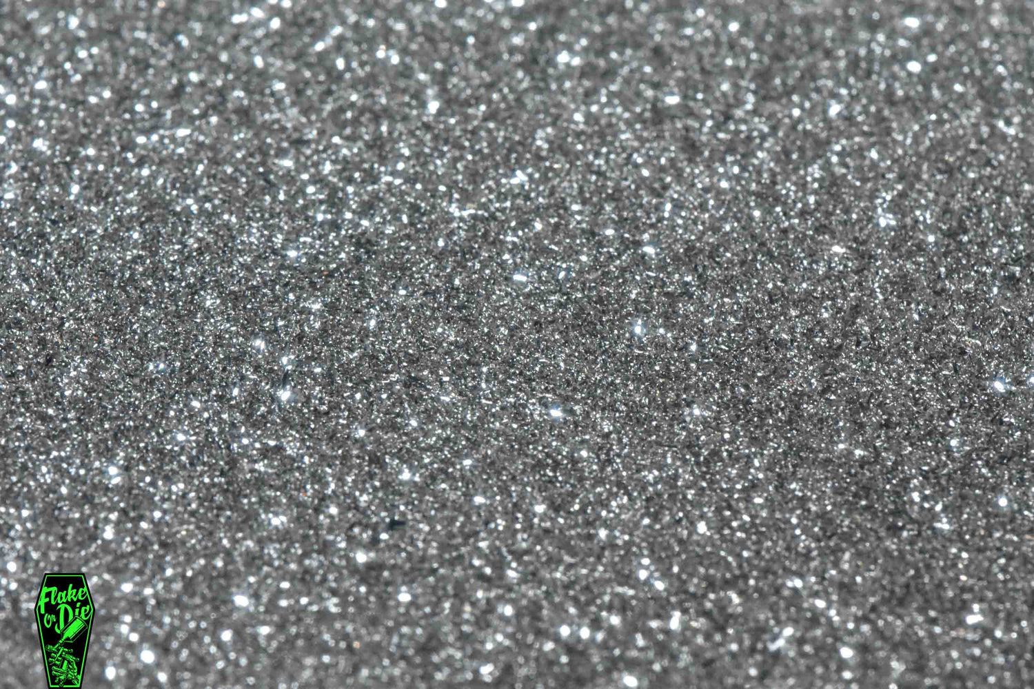 Macro photography product shot of silver glass particles in a small pile.