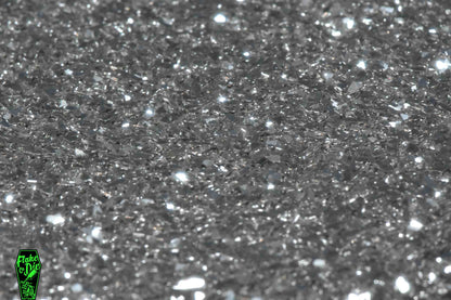 Macro photography product shot of silver glass particles in a small pile.