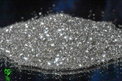 Macro photography product shot of silver glass particles in a small pile.