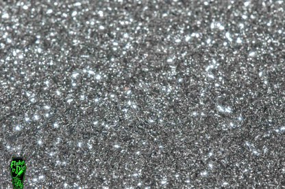 Macro photography product shot of silver glass particles in a small pile.