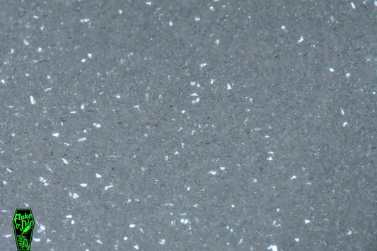 Macro photography product shot of white glass particles in a small pile.