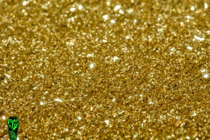 Macro photography product shot of gold glass particles in a small pile.