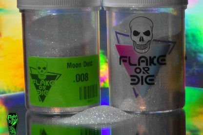 Flake or Die product photography of white iridescent colored metal flake in a clear jar with company logo and product labeling. With a small pile of flake in the foreground.