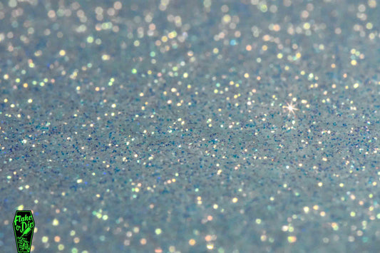 Product photography shot of white colored iridescent metal flake particles smeared flat.