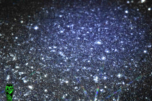 Macro photography product shot of black hex shaped metal flake particles.